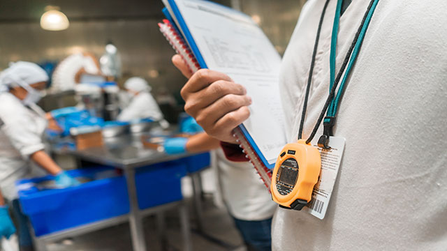 Time and Motion Study being conducted in a food processing or pharmaceutical environment, reflecting a high standard of hygiene and process control