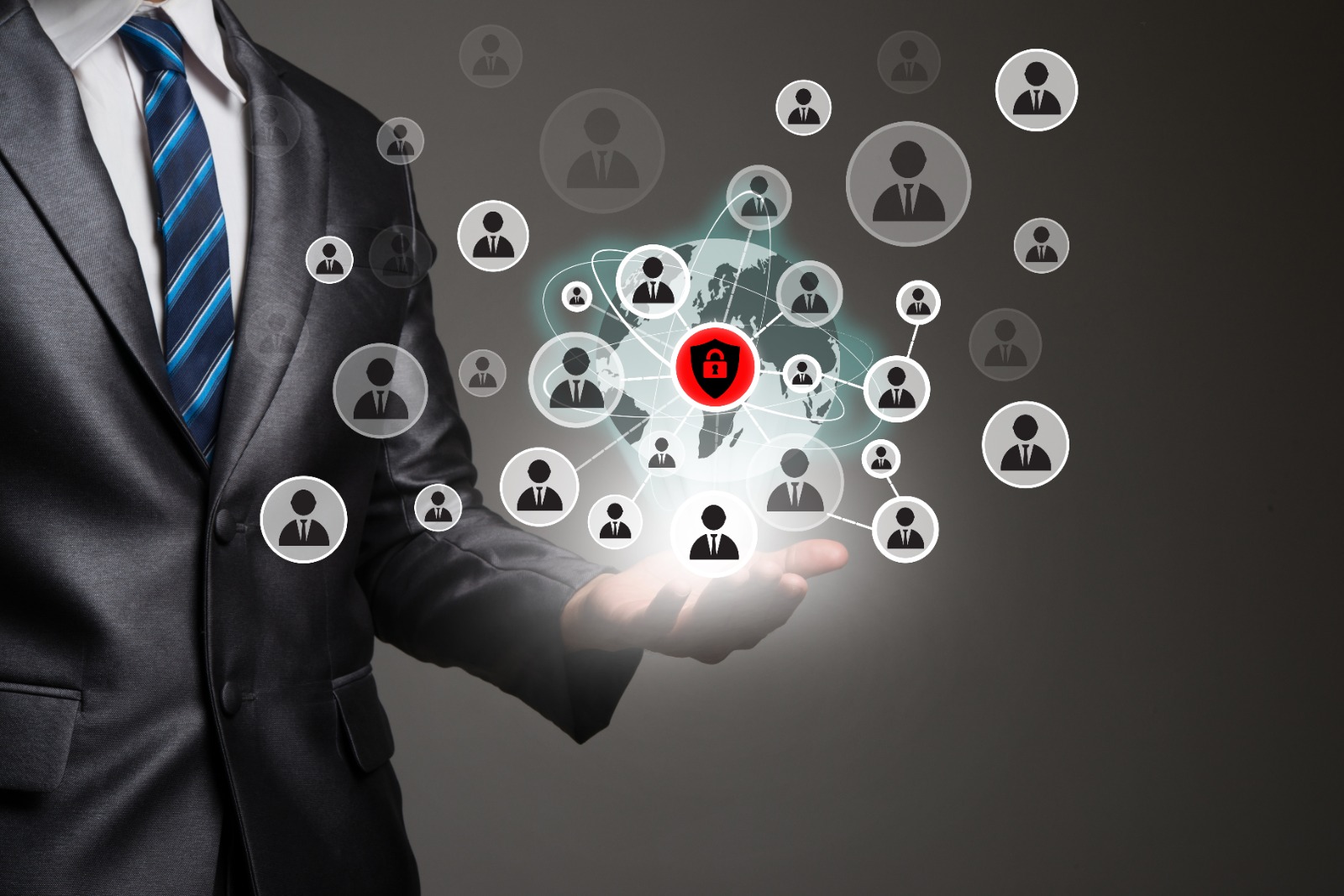 Businessman presenting digital network of connected users with cybersecurity lock icon at the center